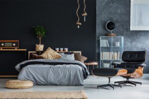 a black bedroom with dark furniture