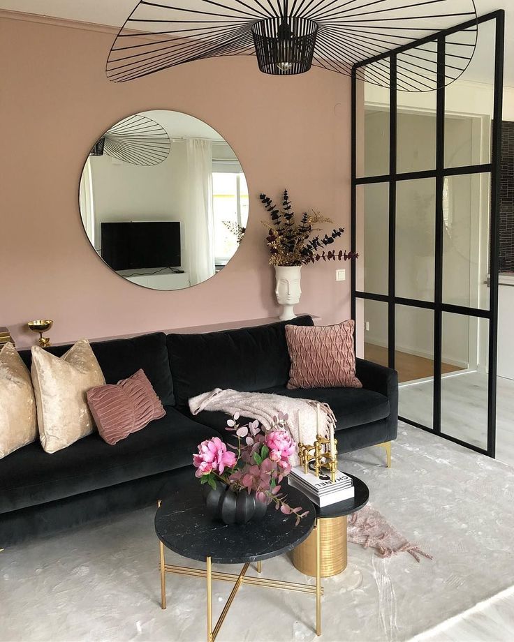 A living room with black and pink accessories 