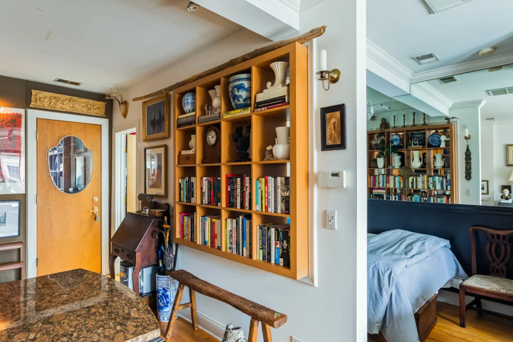 A dorm with a bookshelf partition to create some personal space