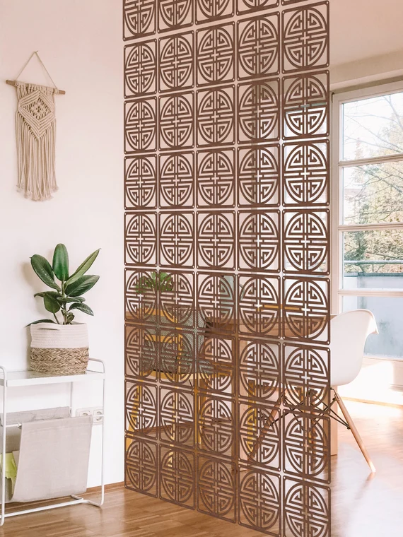 A dorm with a decorative screen to create some personal space