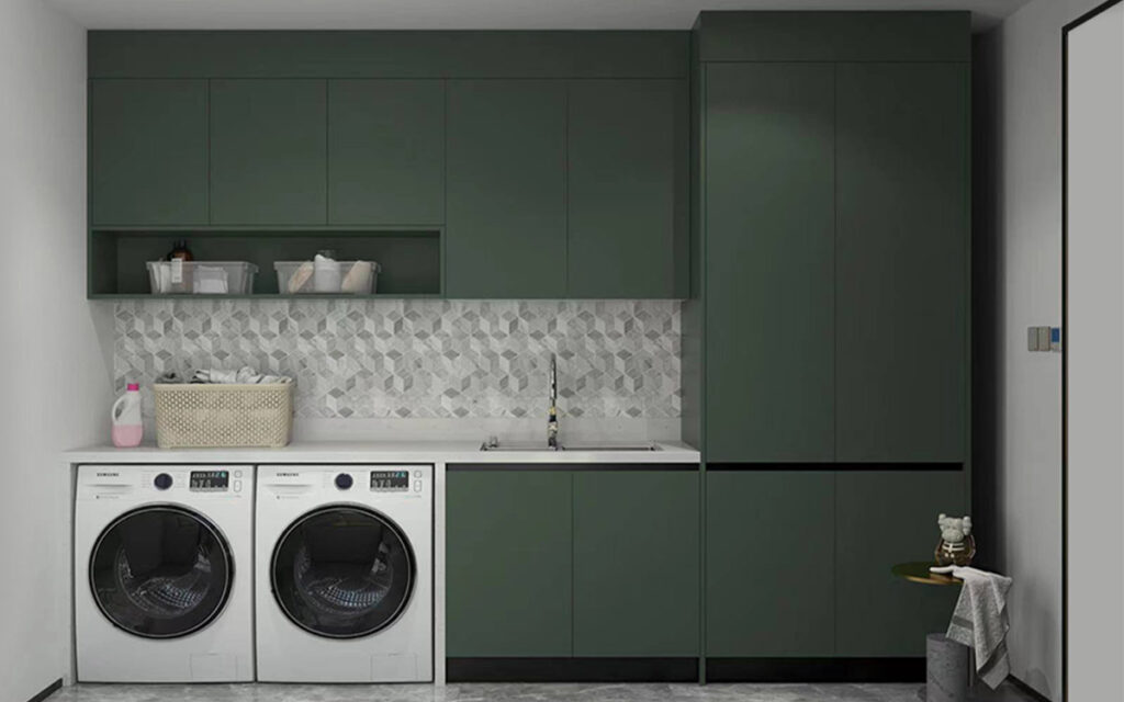 A laundry room with green coloured cabinets 