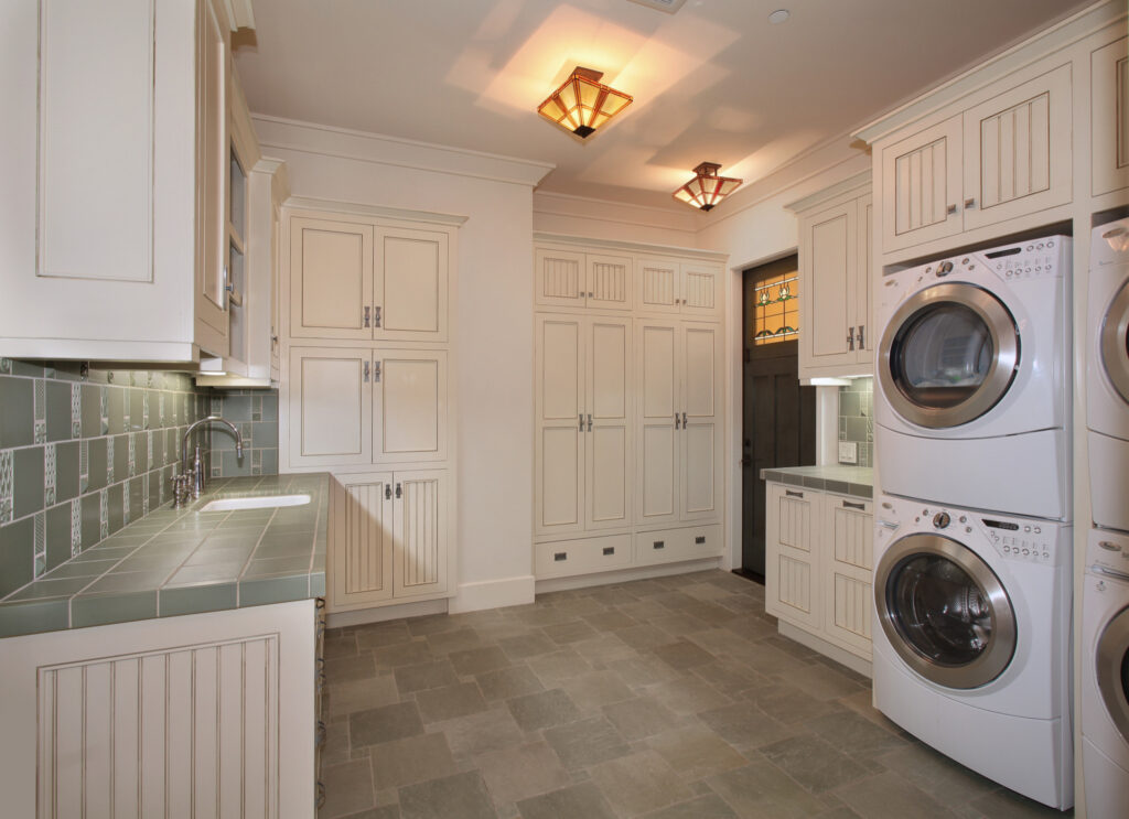 A laundry room with green countertops 