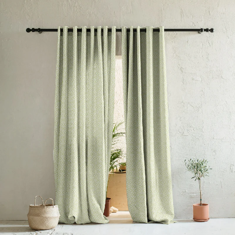 A laundry room with green curtains 