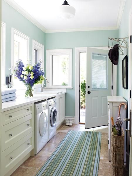 A laundry room with green rugs