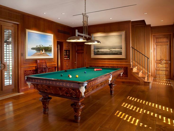 A billiards room with rich wood paneling 