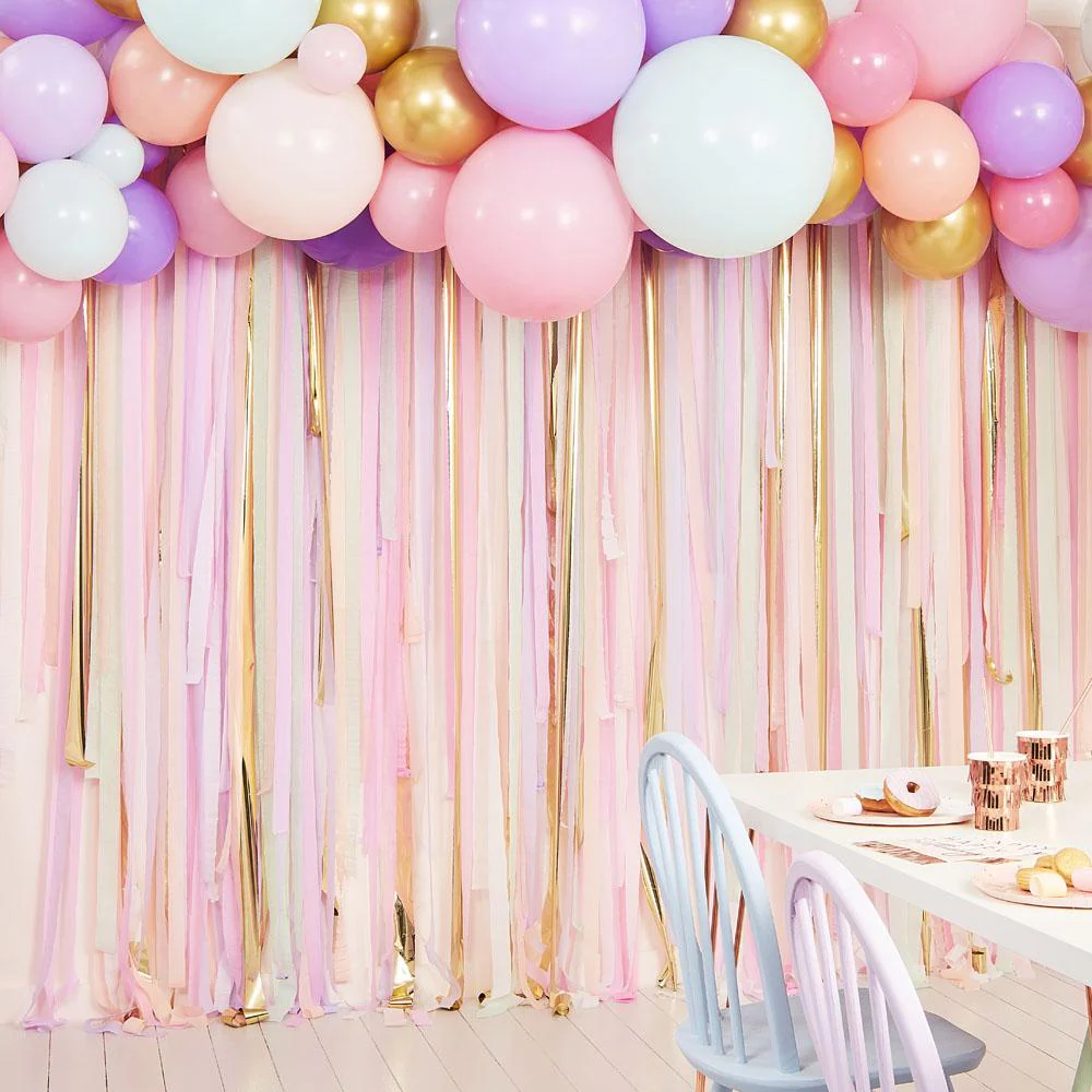 A birthday room with colorful streamers backdrop 