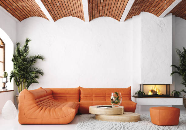 A living room with textured wall and orange couch 