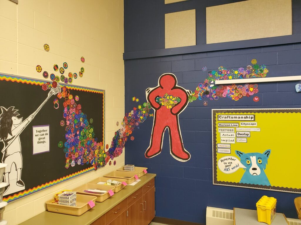 A bulletin board with art in a room 