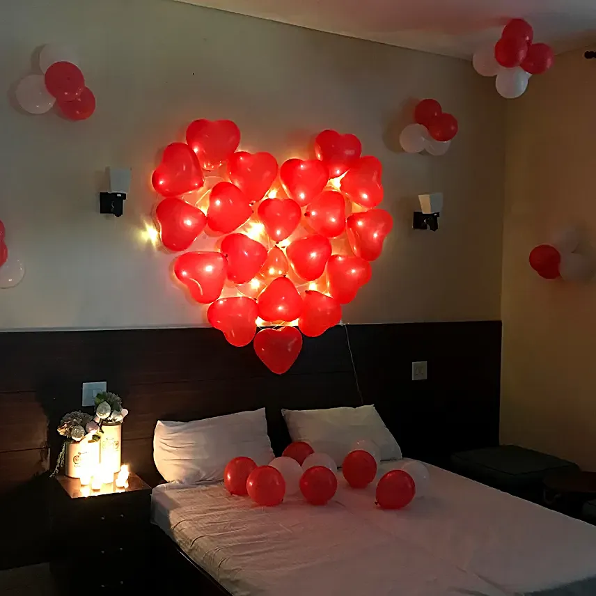 A hotel room with heart shaped confetti 