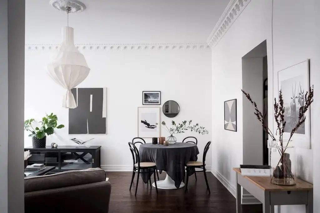 A living room with dark furnitures and light walls 