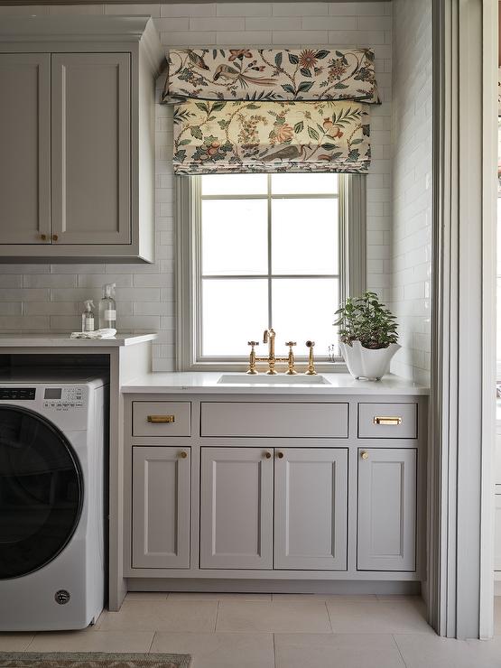 A laundry room with floral artwork 