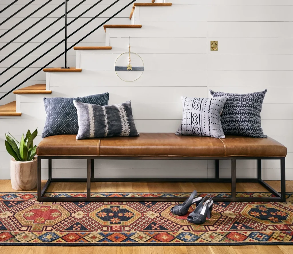 A living room with leather bench 