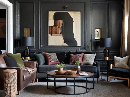 A living room with natural textures and dark furnitures 