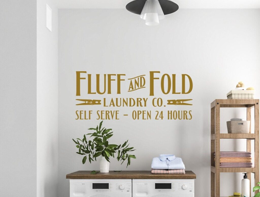 A laundry room with motivational quotes on the walls 