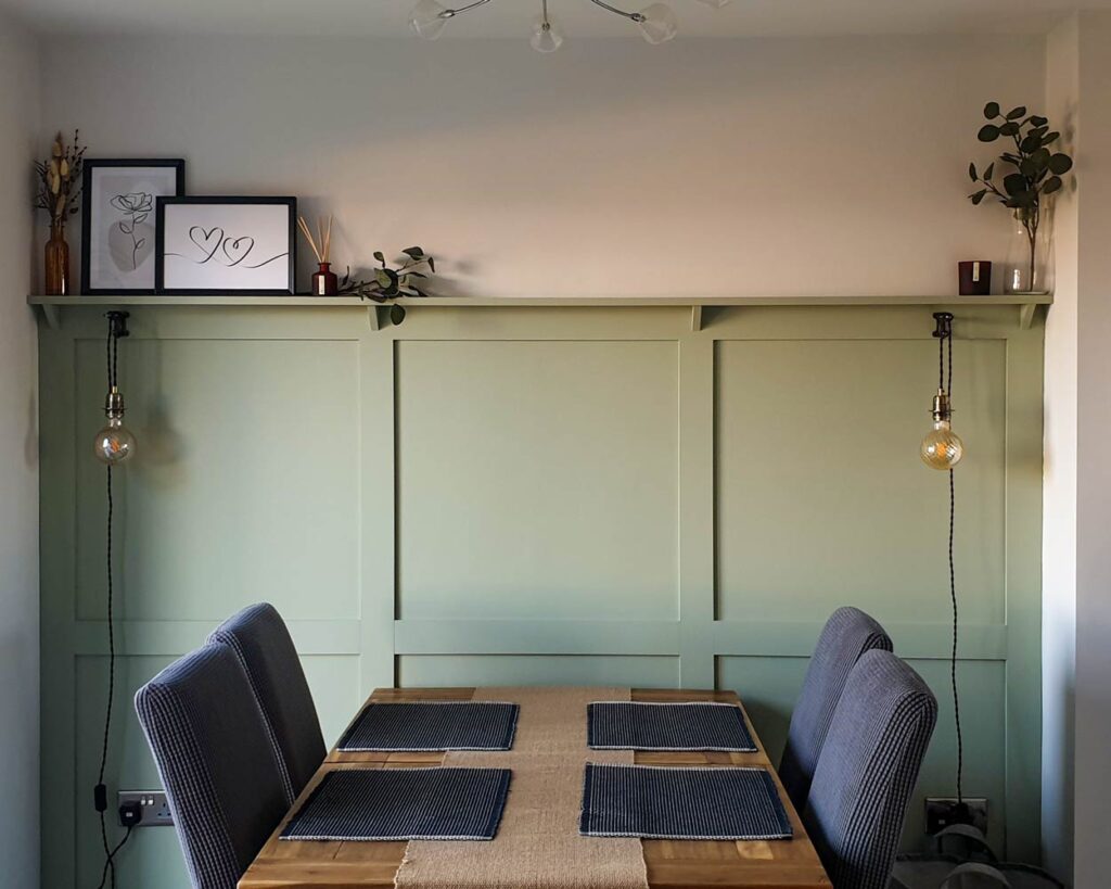 A dining room with shaker style wall 