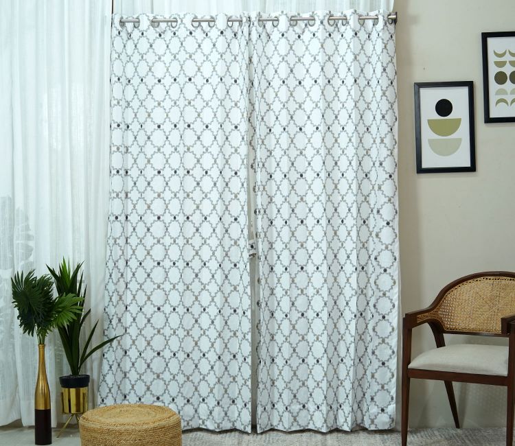 A living room with patterned sheer curtain 