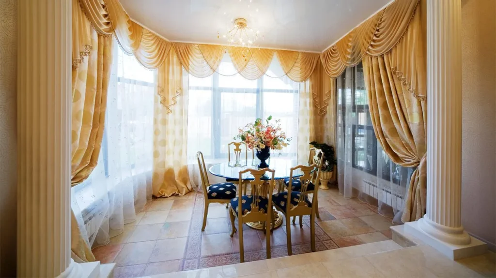 A living room with sheer curtains paired with valances  