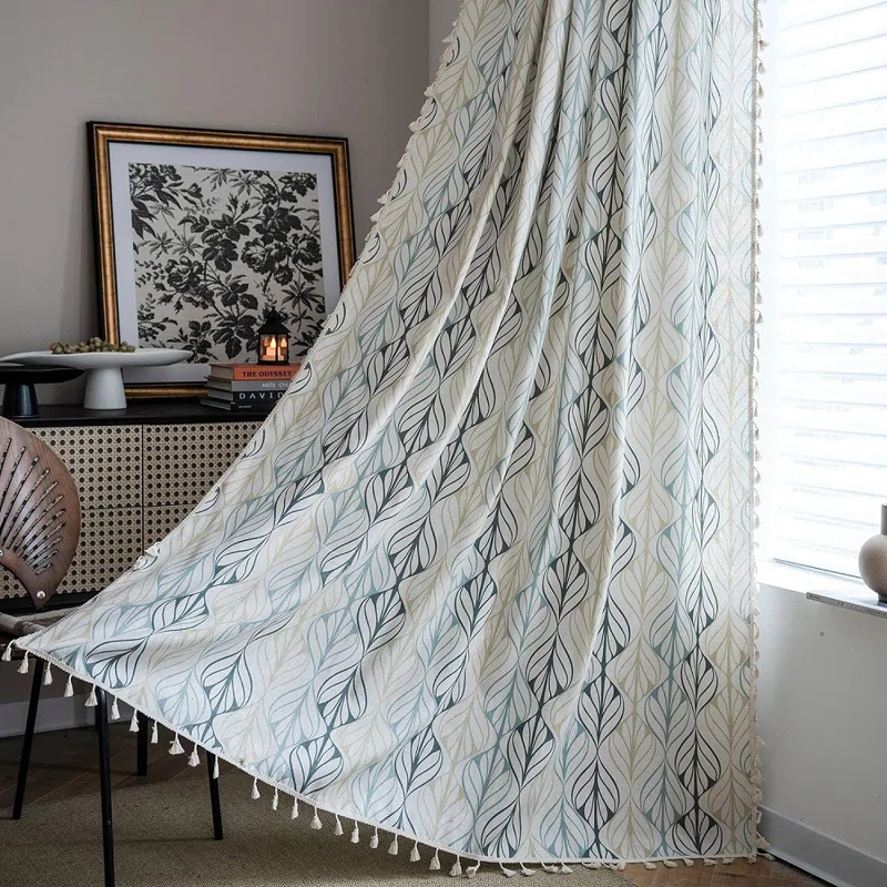 A living room with sheer curtains with tassels 