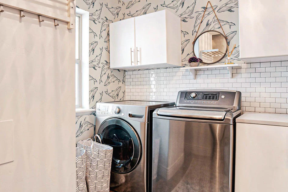 A laundry room with patterned textured wallpapers 