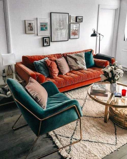 Burnt orange and dark green sofa against cream wall
