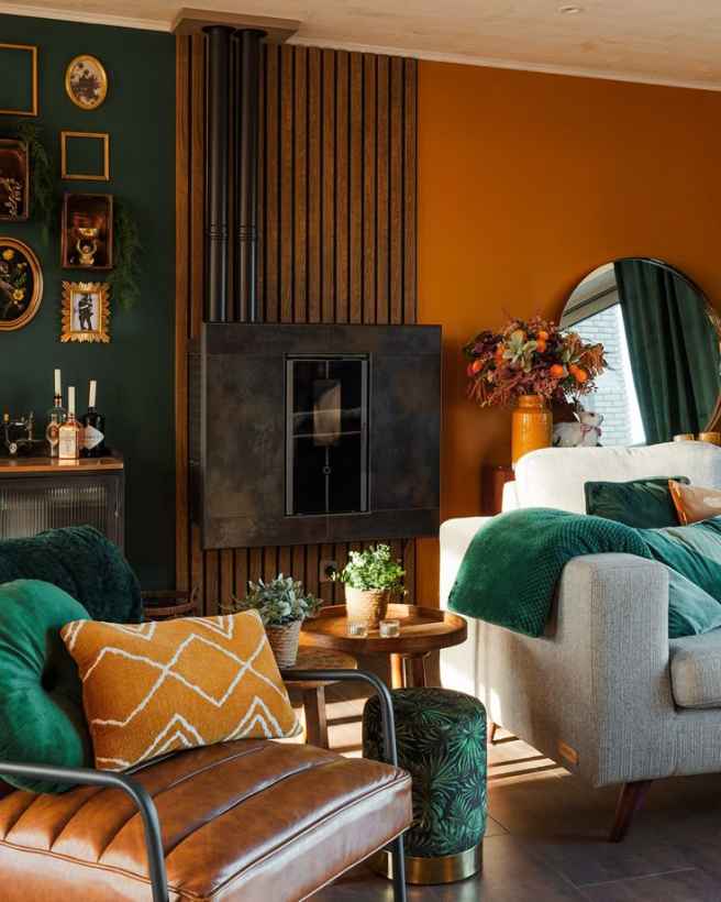 Burnt orange wall white sofa and green accent and a leather arm chair