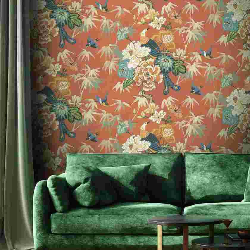 Floral wallpaper paired with velvet green sofa