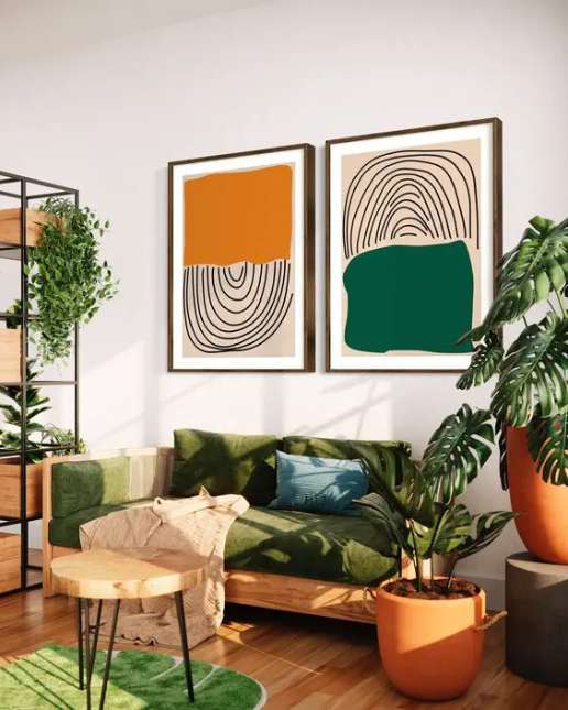 Modern artwork on a wall above a green sofa