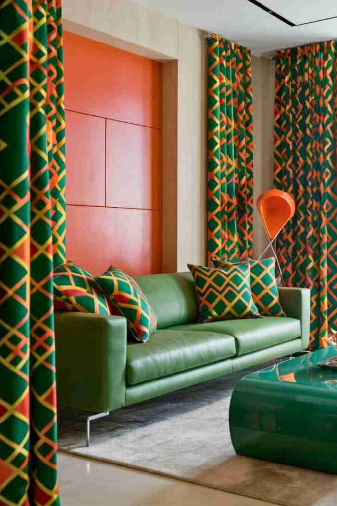 Patterned curtains and pillows with burnt orange wall