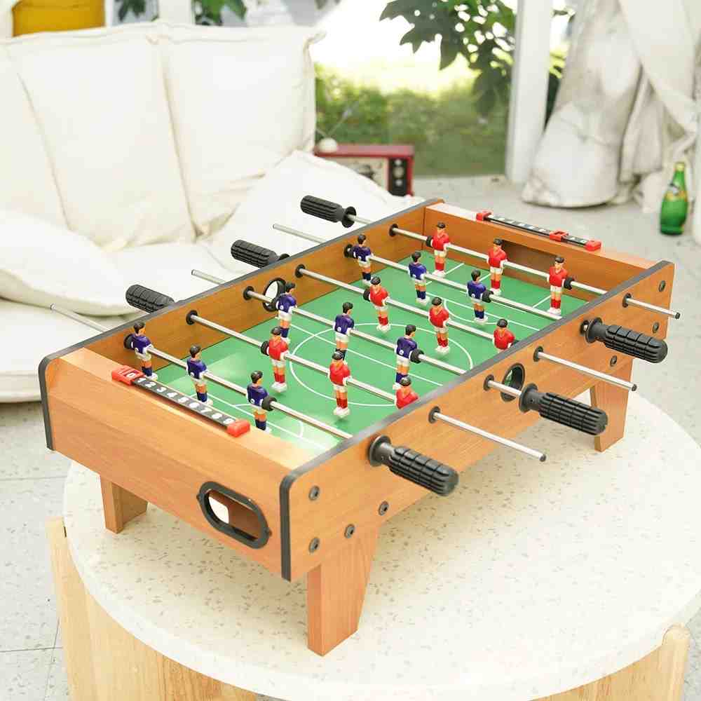 A wooden mini version of foosball table for bedroom