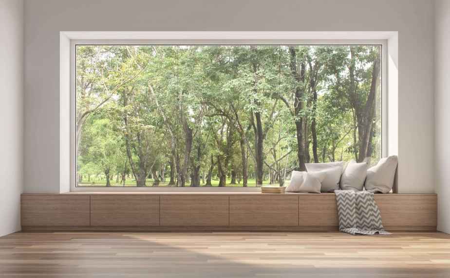 A picture window with wooden seating and cushions