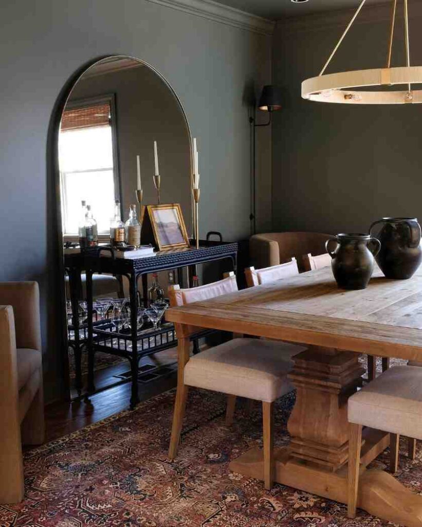 A standing mirror in a dark wood floor in a dining room area