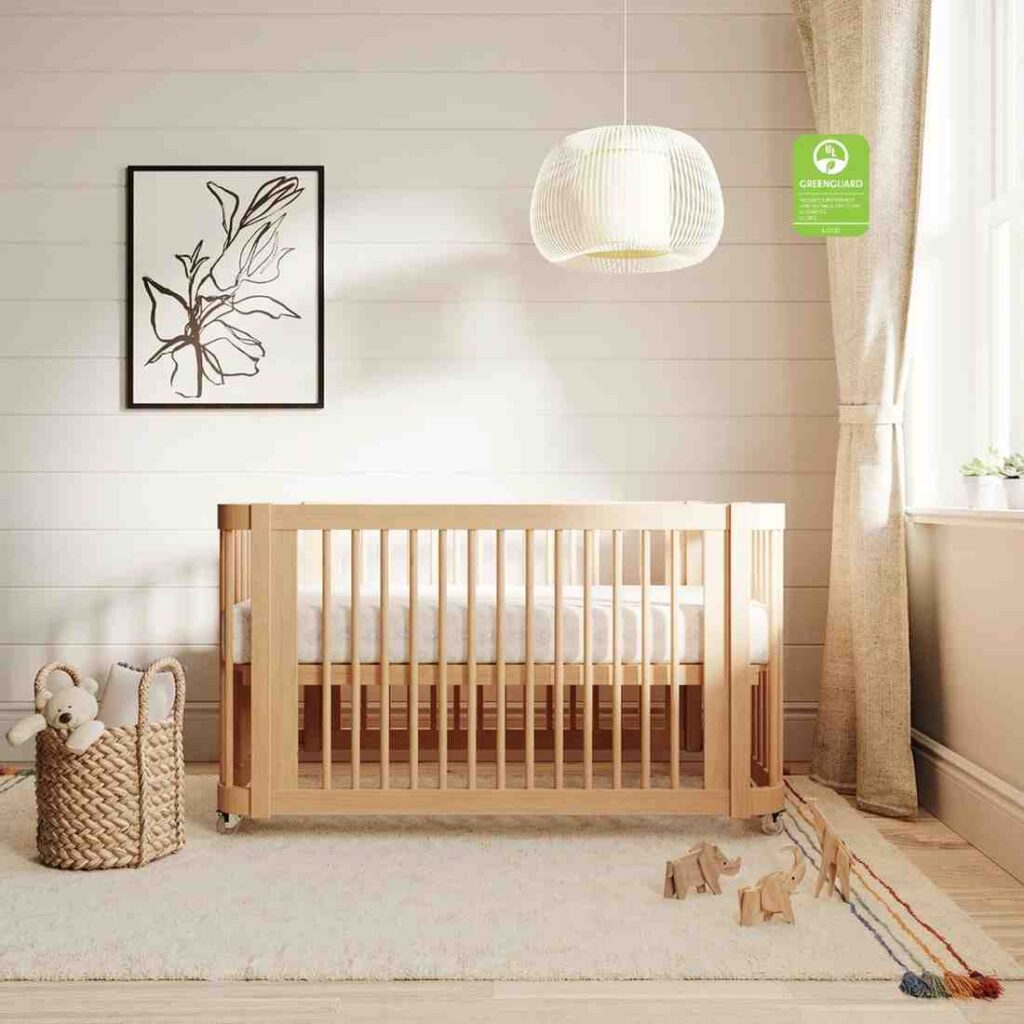 Wooden crib with high sides for the baby with rug laying underneath it