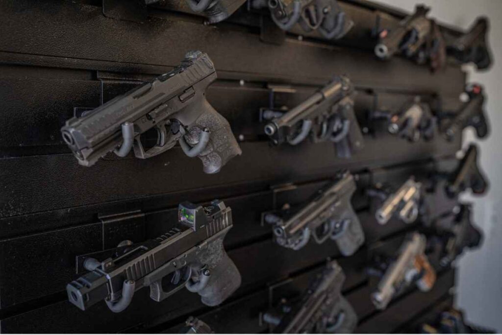 A black built-in wall unit to store guns