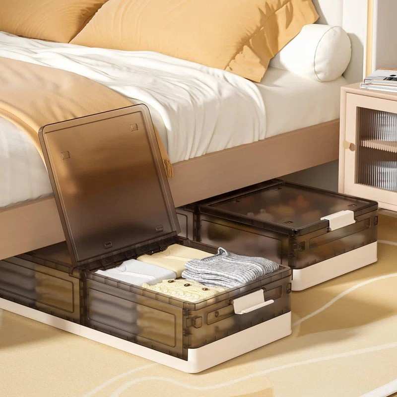 A black and white plastic under bed storage bin for clothes