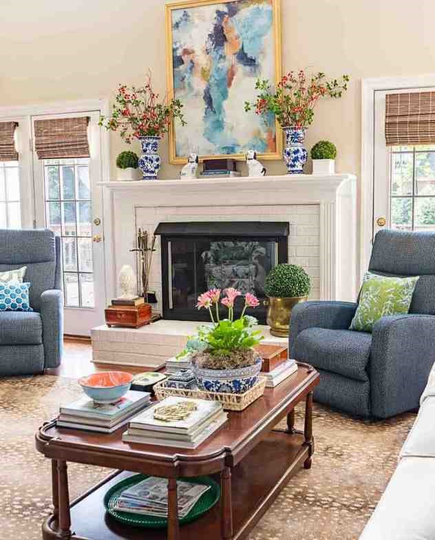 Blue color armchair on a beige rug and a dark wooden table