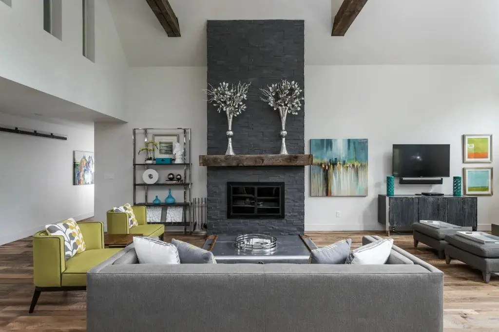 A stoned built dark gray fireplace from floor to ceiling