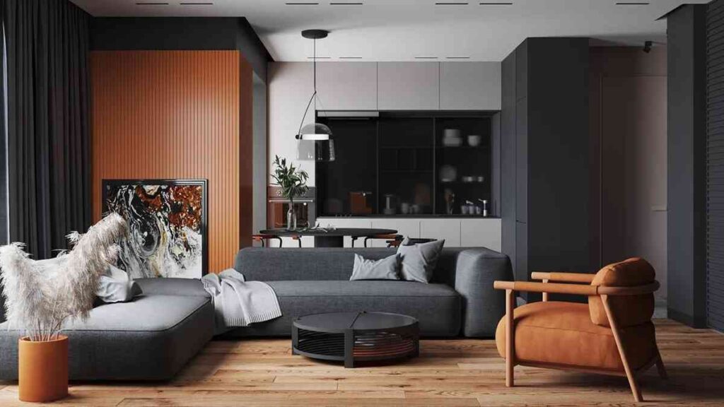 Grey sofa and wall against burnt orange armchair and wall panelling