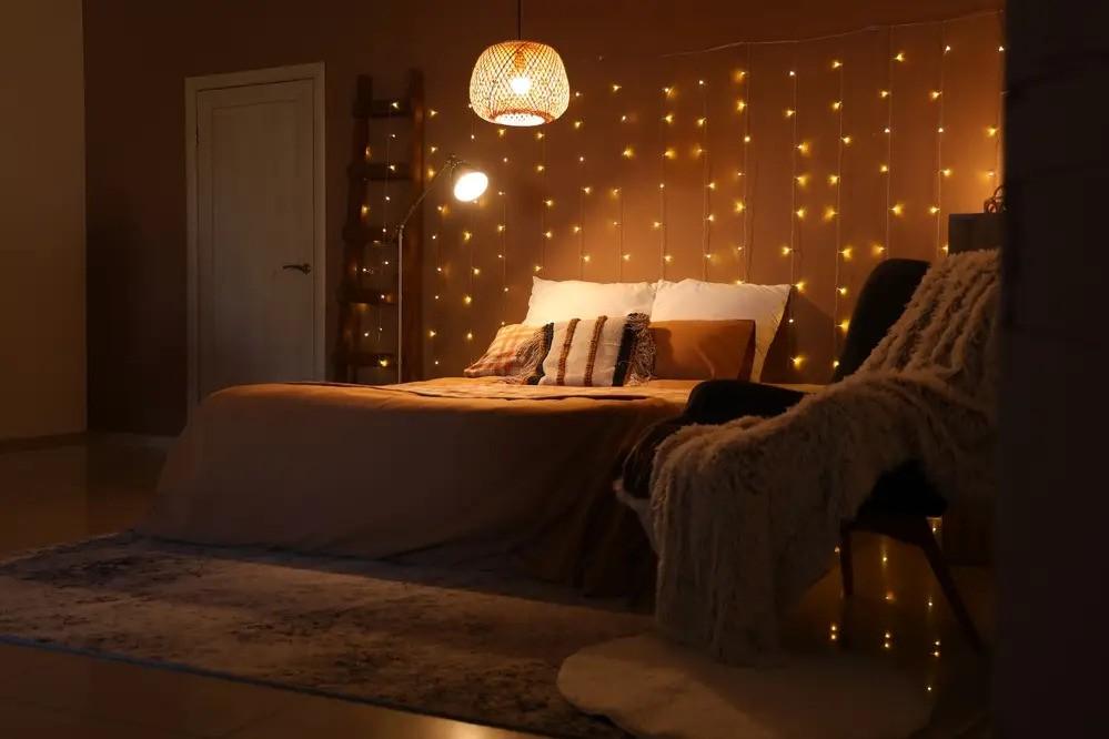 A fairy light wall behind the bed