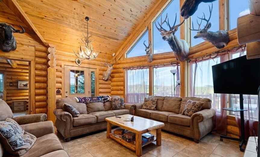 Grey sofa set in a hunting room with a wooden table in center