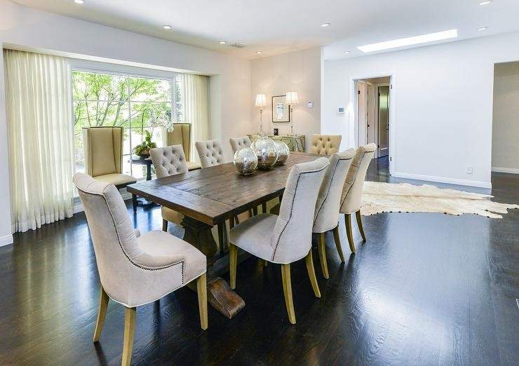 Cream color chair and wooden dining table with dark wood floor
