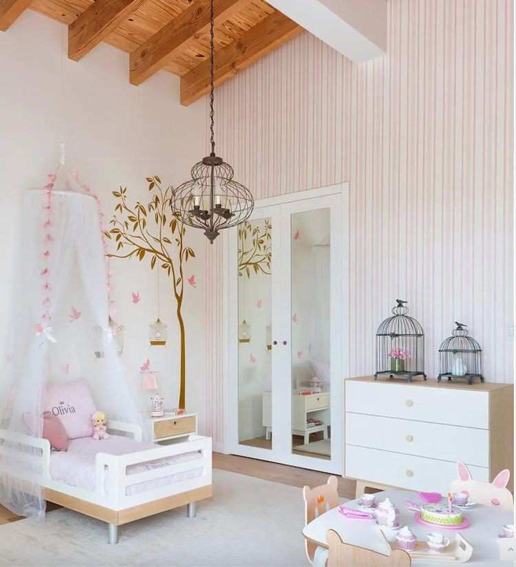 Pink stripped wallpaper and small wooden table and chair set