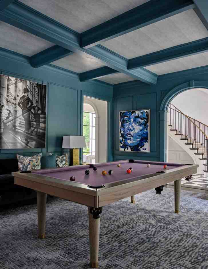 Turquoise wooden beams and purple billiards table for the game room