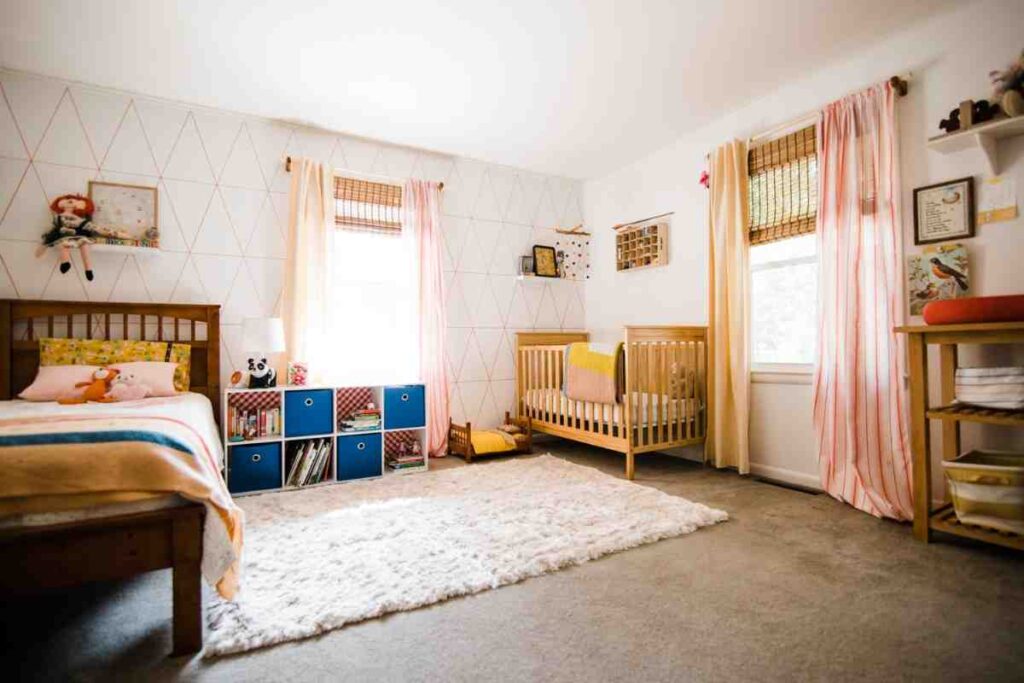White wall for the room and two different sleeping areas for toddler and baby