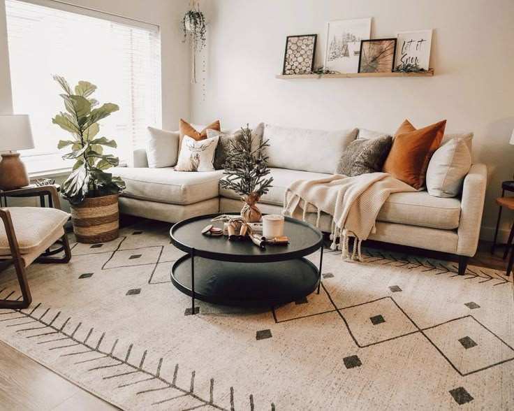 Two layer round coffee table with a monochrome rug and a cloud sofa
