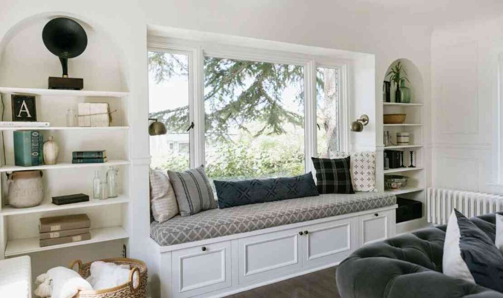 White built in storage unit and picture window with seating