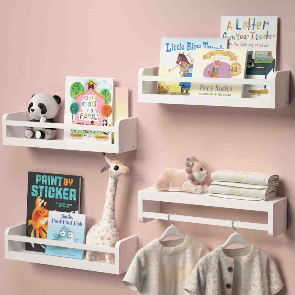 White floating shelves on a pink wall filled with things