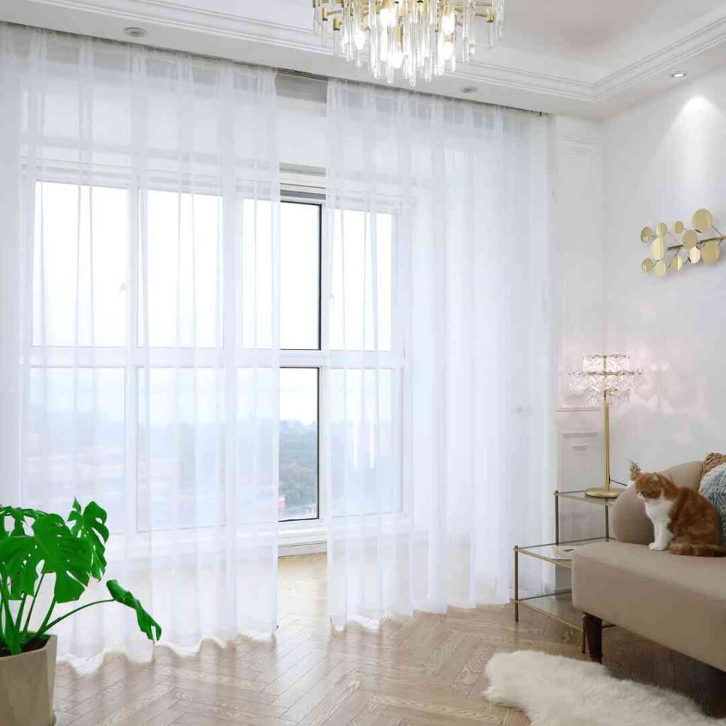 White sheer picture window covering black framed picture window