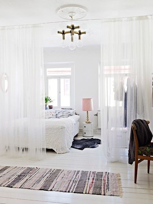 White sheer curtains to define areas in the same room