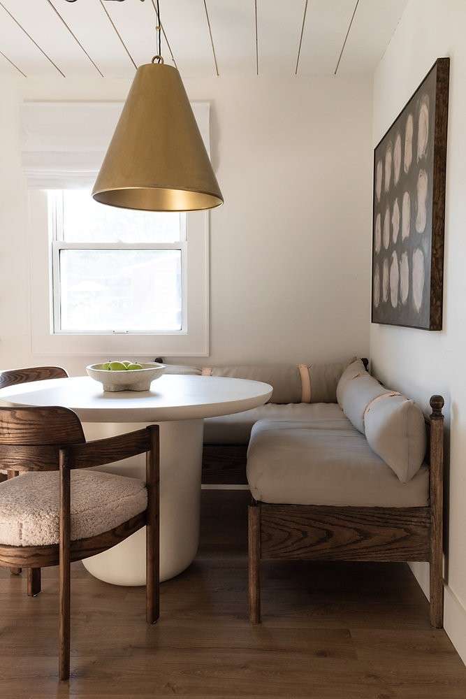 L-shaped wooden bench in dining area paired with table and chair