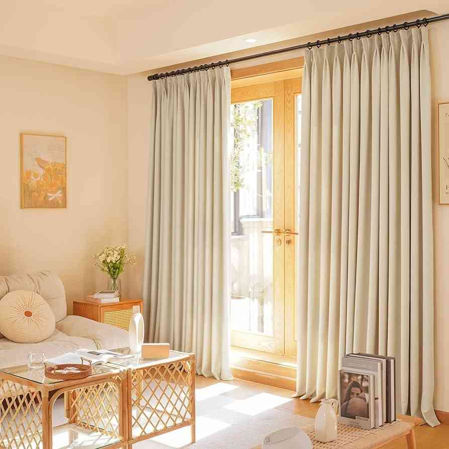 Cream and brown theme living room with soft white floor to ceiling curtains